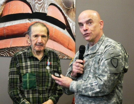 ATG veteran Henry Neligan receives his honorable discharge in 2013 from Maj. Gen. Thomas Katkus.