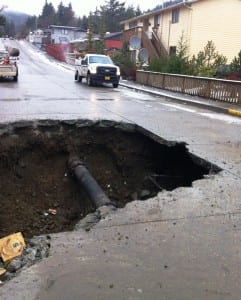 A section of repaired water pipe is seen on Baranof Avenue after the old pipe broke and washed out the fill under the street in 2013. (KRBD file photo by Leila Kheiry)
