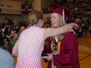 Valedictorian Hayley Jo Nichols receives her diploma from teach Leigh Woodward