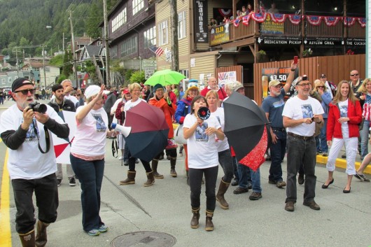 A flash mob halted Ketchikan's Fourth of July parade briefly, as friends and fans of retiring news photographer Hall Anderson, wearing T-shirts printed with his photo, danced and "flashed" cameras at Anderson, the parade grand marshal.