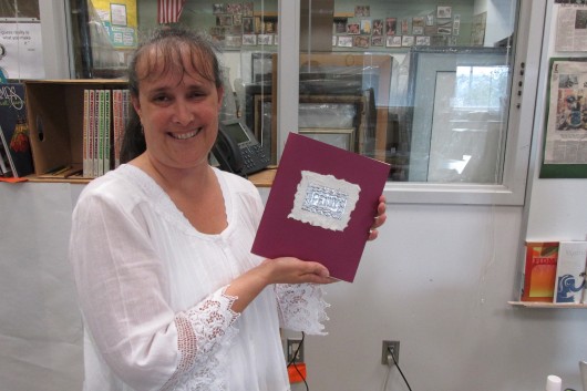 Penny Ranniger, a librarian at Houghtaling, shows a journal she made at the Basic Arts Institute.