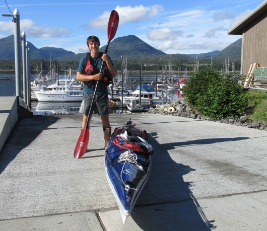 Zachary Brown stands with his kayak at Bar Harbor before continuing his journey home to Gustavus.