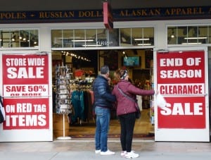 Tourists consider checking out a sale on South Franklin Street, Juneau’s gift-shop row, on Sept. 24. (Photo by Ed Schoenfeld/CoastAlaska News)