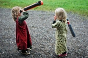 Two young member of Erleninsel play with the kid-sized rattans.