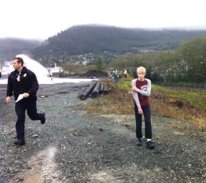 Robbie Wickman wanders from the crash scene, clutching his "wounded" arm.