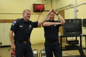 Frank Divelbiss, left, and Terry Roberts give a visual demonstration of the three prongs of a fire: heat, fuel and oxygen.