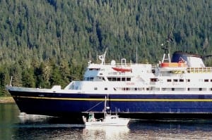 A Petersburg fishing boat passes the ferry Taku near the entrance of Wrangell Narrows in August, 2013. (Ed Schoenfeld/CoastAlaska News) A Petersburg fishing boat passes the ferry Taku near the entrance of Wrangell Narrows in August, 2013. The ship is tied up and will continue to be until it's sold or scrapped. (Photo by Ed Schoenfeld/CoastAlaska News)