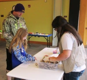 Girl Scout Karri Montero demonstrates her cat-toy-making skills.