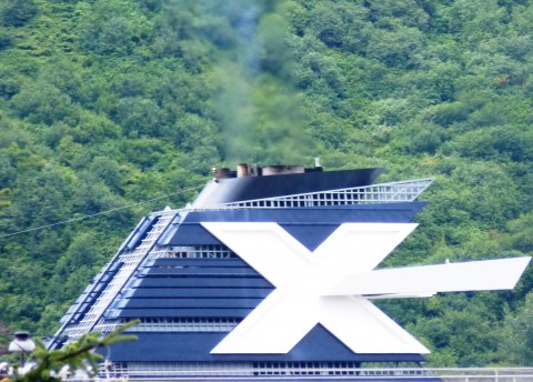 A Celebrity Cruise Line ship sails into Juneau in 2012 with emissions coming out of its stack. New pollution-control equipment being installed on Alaska-bound and other ships will reduce the emissions plume. (Ed Schoenfeld/CoastAlaska News)