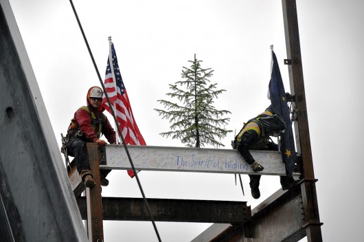 Construction crew members sign the final I-beam for the PeaceHealth Ketchikan Medical Center four-story addition. (Photo courtesy PeaceHealth)