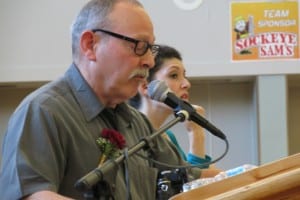 Commencement speaker Hall Anderson (Sign language interpreter Sara Dyck is in the background).