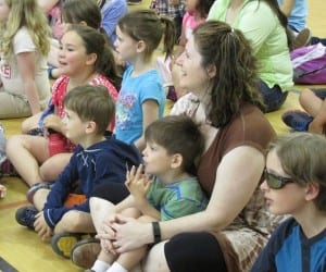 Families enjoy a short preview of the Chautauqua variety show before the workshops start at the Gateway Rec Center.