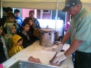 KIC Culture Camp participants learn how to fillet a salmon. (Photo by Madelyn Beck)