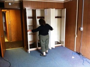 Kathleen Light looks into a closet in one of the Main Street fire hall's upstairs bedrooms.