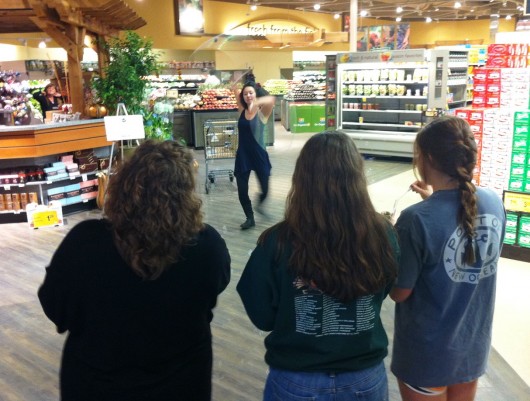 Tika Hoop performs at Carrs-Safeway while bystanders blow bubbles.