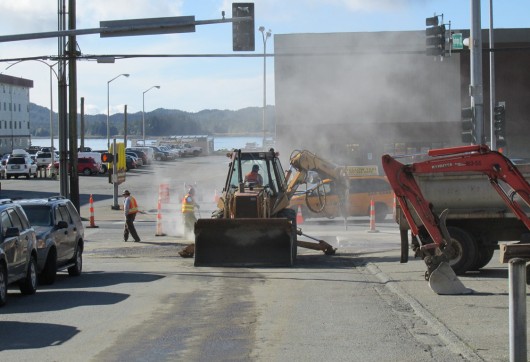 Crews repair the street after fixing a broken water main at Tongass and Washington Wednesday morning. (Photo by Leila Kheiry)