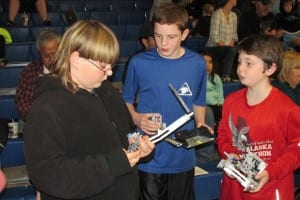 The Coffman Cove "Timber Wolves" checking the components for their robots.