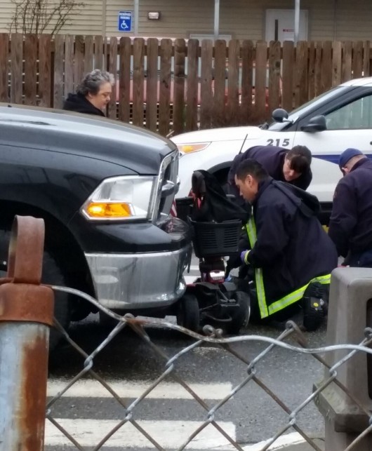 Paramedics respond to an accident on Tongass Avenue. A woman in a scooter was struck by a vehicle. (KRBD photo by Deb Turnbull)