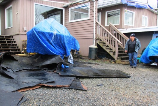 Roofing material is seen in the yard in front of Frank and Marge James' rented home off North Tongass Highway. The roof blew off in the storm earlier this week. (Photo by Leila Kheiry)