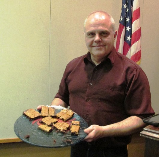 Mayor Lew Williams III with "special" brownies he passed out during his presentation to the Chamber of Commerce. The brownies didn't contain any cannabis; It was a joke. (Photo by Leila Kheiry)
