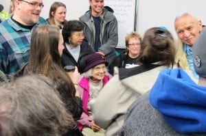 Delores Churchill is surrounded by family and friends at Saturday's Democratic caucus in Ketchikan. (Photo by Leila Kheiry)