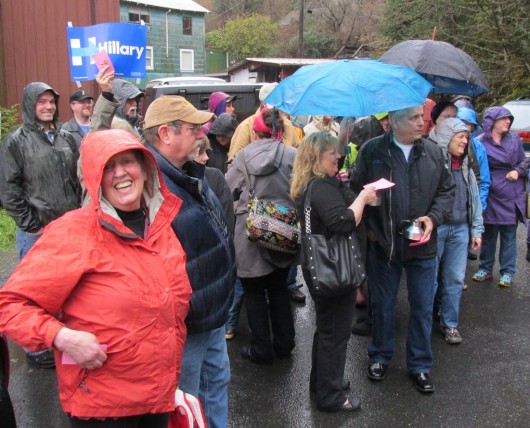 Hillary Clinton supporters caucus in the rain. (Photo by Leila Kheiry)