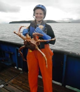 Leah Sloan shows off a red king crab she collected during an Alaska Department of Fish and Game survey in summer of 2015 (Photo courtesy Leah Sloan)