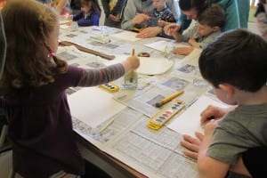 Preschoolers try their hands at crayon resist art.