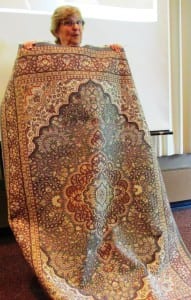 Diane Gubatayao holds up a handwoven rug that she bought during a trip to India with a local Rotary group. (Photo by Leila Kheiry)