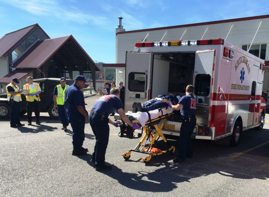 EMTs load a "victim" into an ambulance during an active shooter drill at the Ketchikan Coast Guard base. (Photo by Leila Kheiry)