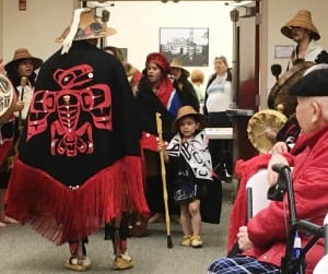 Kevin Clevenger displays his regalia as the New Path Dancers enter the Saxman Community Hall on Wednesday. (Photo by Leila Kheiry)