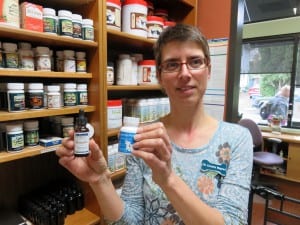 Dr. Cornelia Wagner shows several hemp-based supplements for pets stocked by the Hawthorne Veterinary Clinic. (NNN photo by Tom Banse)