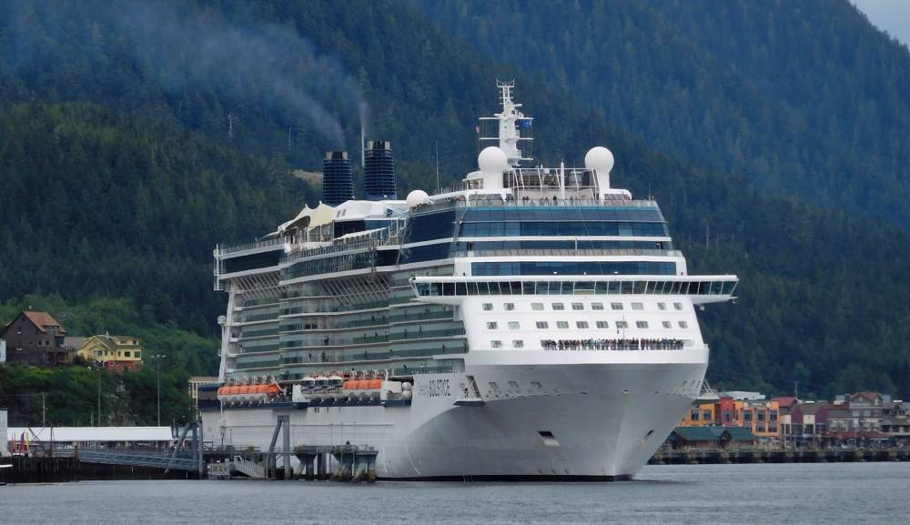 Passengers stand on the deck of the Celebrity Solstice in Tongass Narrows on June 5, 2016. City officials worry changes in cruise ship passenger fees could reduce funding for docks and related infrastructure improvements. (Ed Schoenfeld/CoastAlaska News)