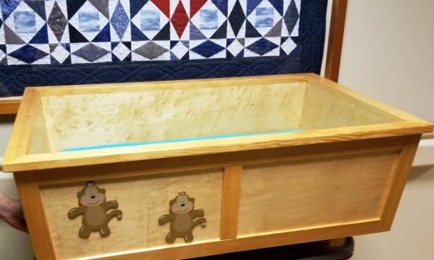 Local police sergeant donates handmade cradle