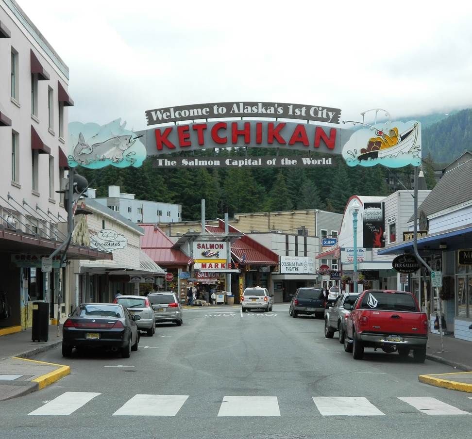a large sign over a downtown street