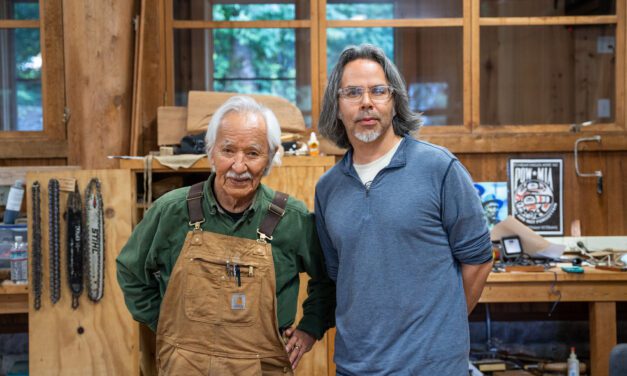 Decorated Ketchikan carvers and apprentices work on totem poles to be raised in Juneau